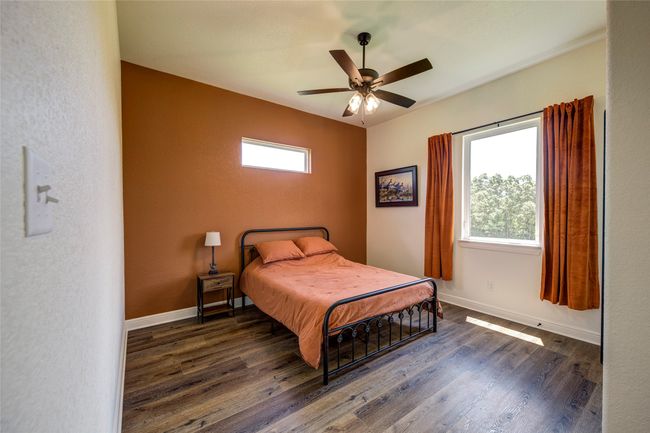 Bedroom featuring ceiling fan and dark wood-type flooring | Image 28