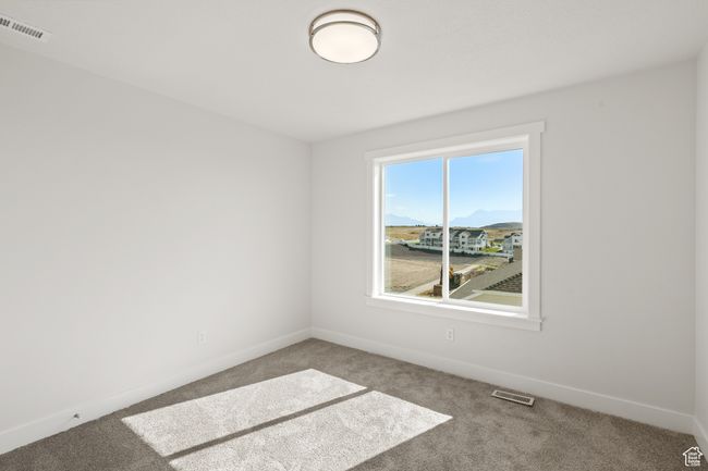 Carpeted empty room featuring baseboards | Image 25