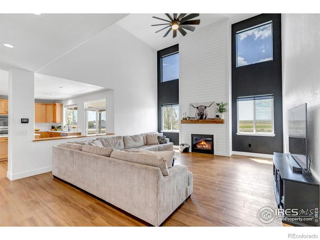 Expansive two-story living room with floor to ceiling shiplap fireplace and mountain views! | Image 10