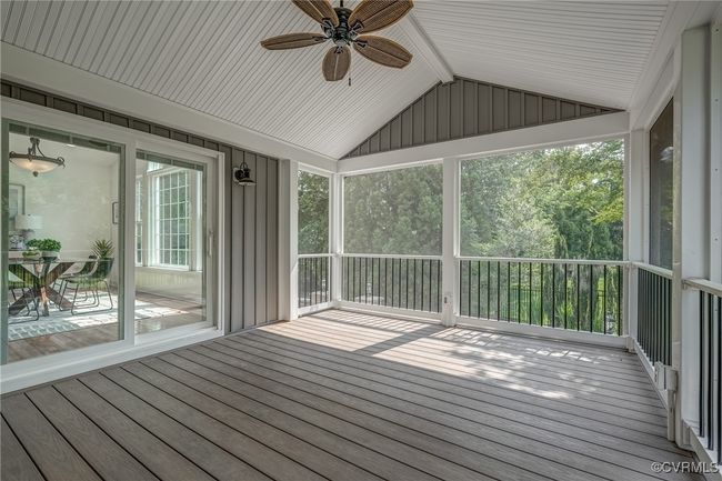 Enjoy evenings on the screened-in porch with a ceiling fan and lights, or entertain on the custom patio below. | Image 45