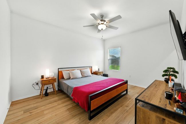 Bedroom featuring light wood-type flooring and a ceiling fan | Image 14