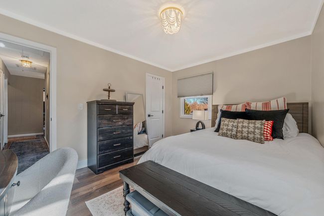 Bedroom featuring ornamental molding and dark hardwood / wood-style flooring | Image 13