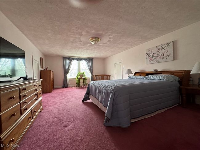 2nd floor Carpeted bedroom featuring a textured ceiling | Image 29