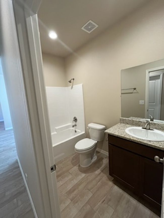 Full bath featuring wood finished floors, toilet, vanity, and baseboards | Image 17