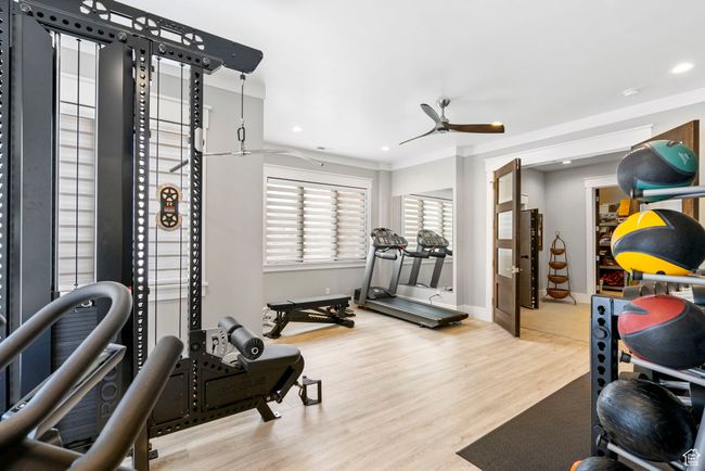 Workout room featuring recessed lighting, baseboards, a ceiling fan, and wood finished floors | Image 81