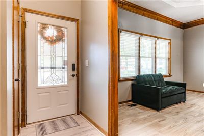 Entryway with a healthy amount of sunlight, light hardwood / wood-style flooring, and crown molding | Image 3