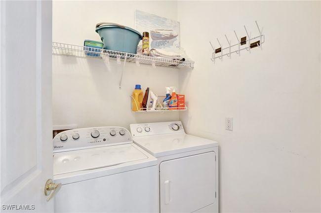 Laundry room featuring independent washer and dryer and storage space | Image 34