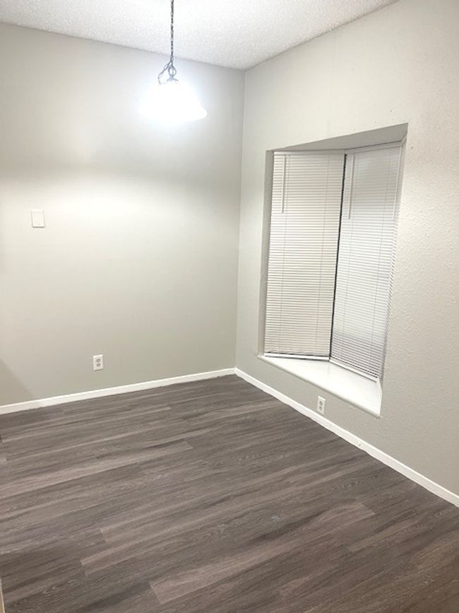 Unfurnished room with dark wood-style flooring, baseboards, and a textured ceiling | Image 4