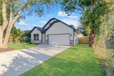 View of front of home featuring a garage and a front lawn | Image 1