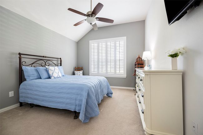 Bedroom 2 featuring lofted ceiling, light carpet, baseboards, and ceiling fan | Image 20