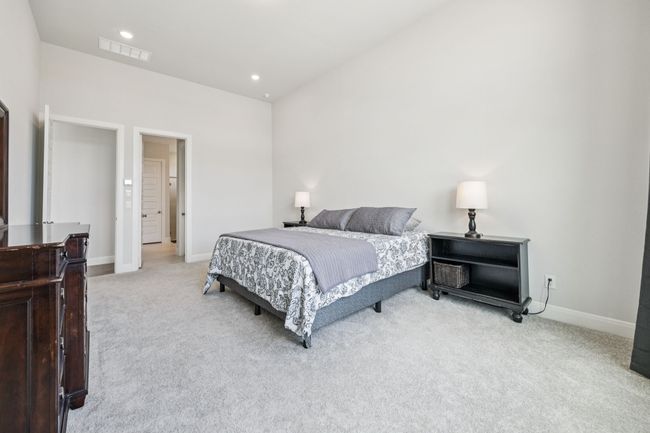 Bedroom with light carpet, baseboards, and recessed lighting | Image 15