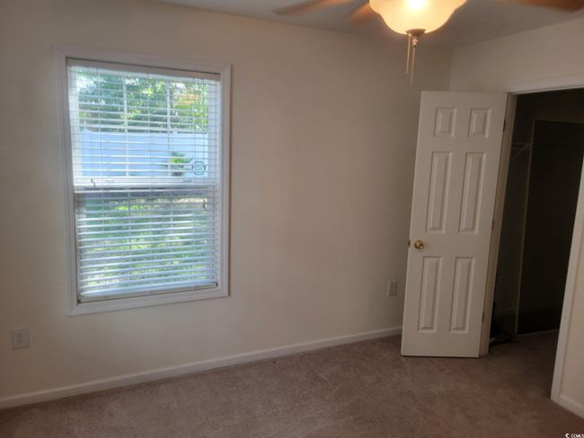 Unfurnished bedroom with light colored carpet and baseboards | Image 19