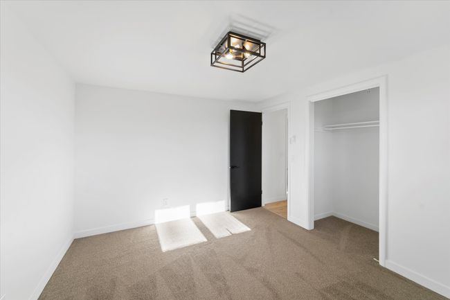 Unfurnished bedroom featuring a closet and light colored carpet | Image 34