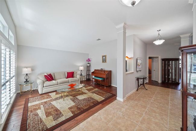 Your guest walk through the front door to a large open area and many windows to let the light in. This is a great front room to be used as many flex options. | Image 26