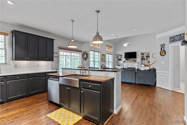 Kitchen with a wealth of natural light, an island with sink, dishwasher, and a sink | Image 10