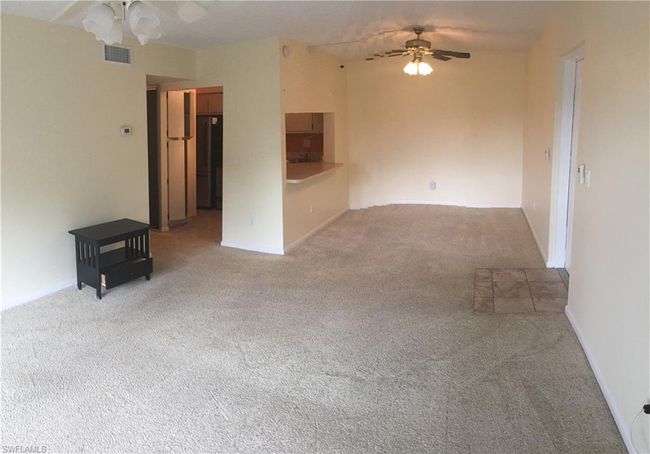 Unfurnished living room featuring ceiling fan and carpet flooring | Image 6