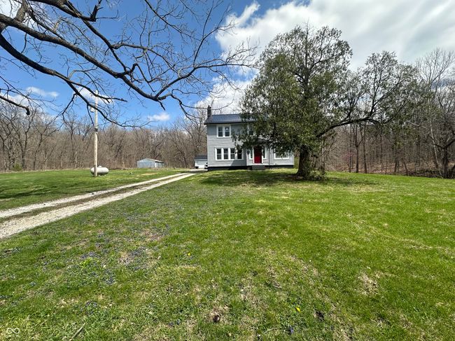 view of front of property featuring a front yard and driveway | Image 14