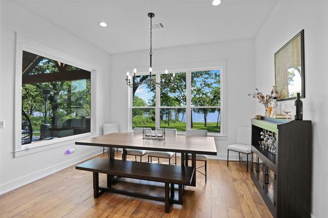 Dining space featuring baseboards, light wood-style flooring, visible vents, and an inviting chandelier | Image 14
