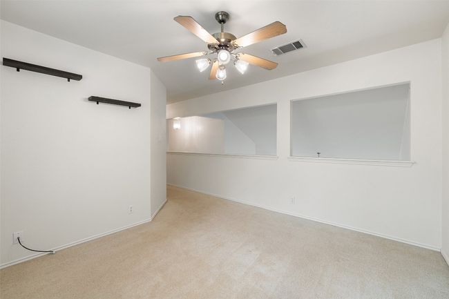 Carpeted empty room with baseboards, ceiling fan, and visible vents | Image 32