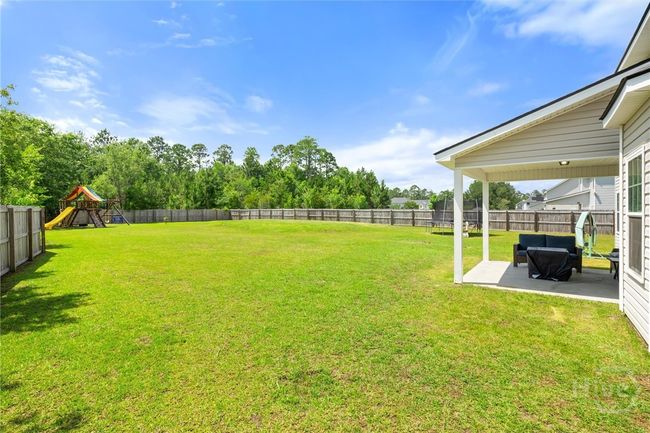 The patio offers views of the huge backyard. | Image 37