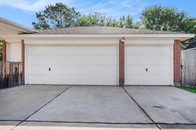 3-car detached garage. One bay has been converted into full storage area | Image 6
