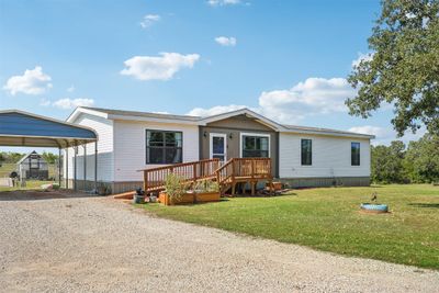 Manufactured / mobile home with a deck, a carport, and a front lawn | Image 2