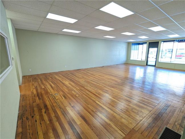 Unfurnished room featuring a paneled ceiling and wood-type flooring | Image 13