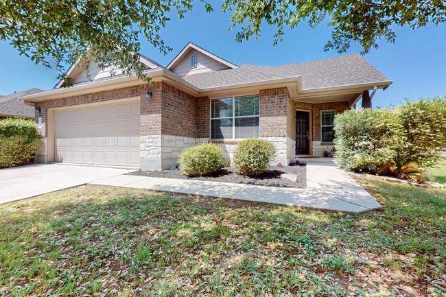 Ranch-style house featuring an attached garage, a shingled roof, driveway, and brick siding | Image 22