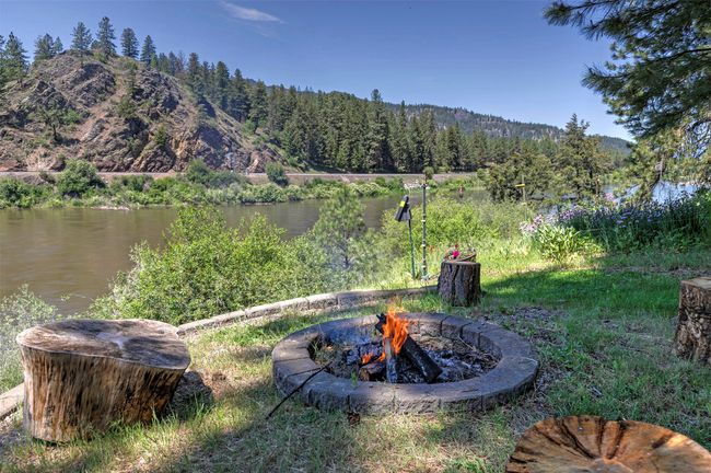 View of yard with a fire pit, a view of trees, and a water and mountain view | Image 54