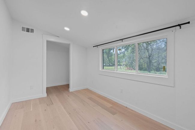 Unfurnished room featuring vaulted ceiling, light wood-style flooring, and recessed lighting | Image 18