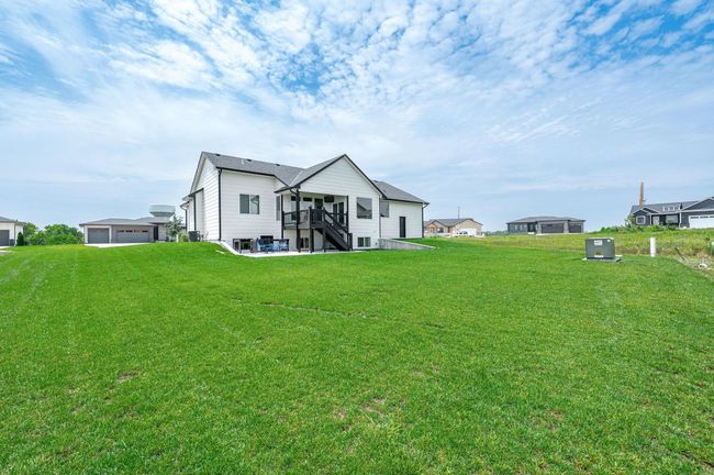 Rear view of house with stairway, a yard, a detached garage, and a deck | Image 35