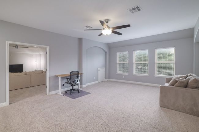 Carpeted office space with ceiling fan and baseboards | Image 21