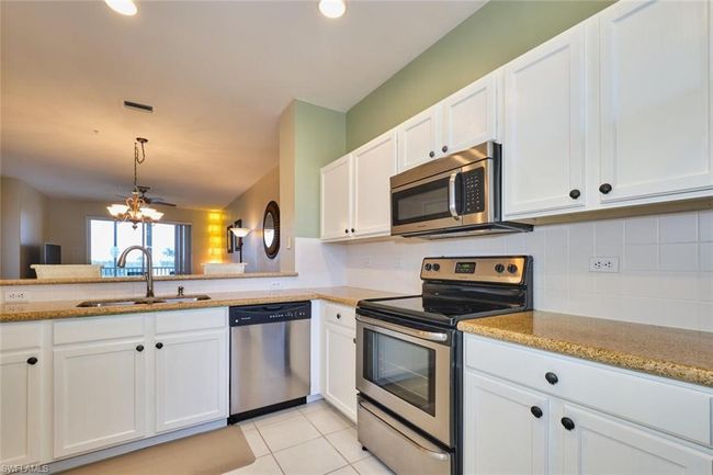 Kitchen with stainless steel appliances, tasteful backsplash, visible vents, and a sink | Image 18