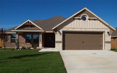 Craftsman inspired home with a garage and a front lawn | Image 2