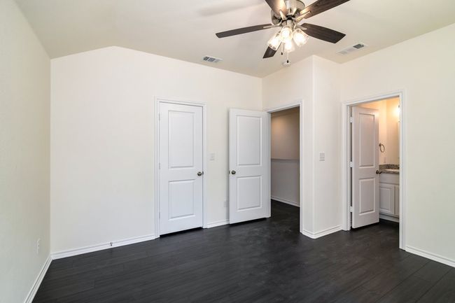 Unfurnished bedroom with ceiling fan, dark hardwood / wood-style floors, and a closet | Image 14