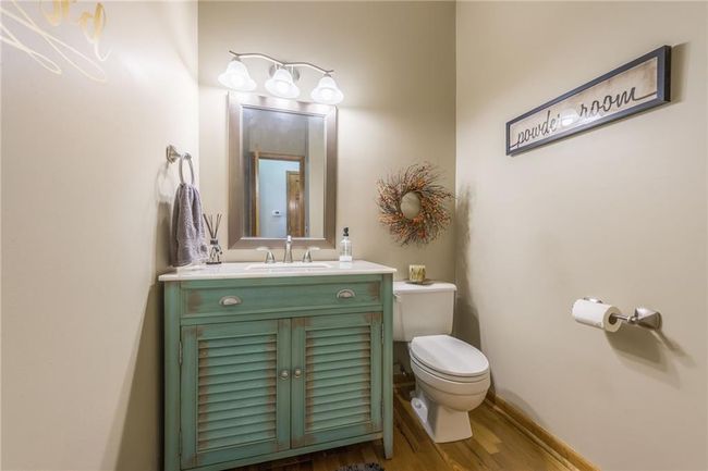 Bathroom with toilet, baseboards, vanity, and wood finished floors | Image 44