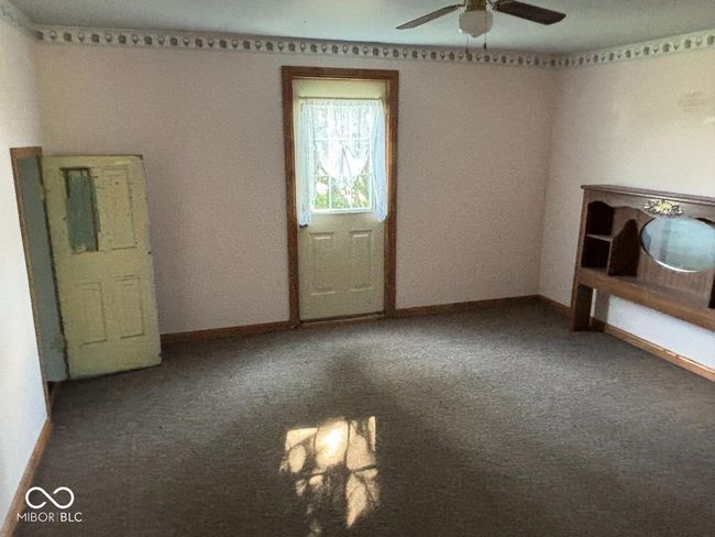 unfurnished room with baseboards, a ceiling fan, and carpet | Image 7