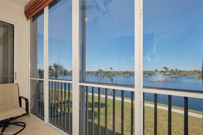 Unfurnished sunroom with ceiling fan and a water view | Image 8
