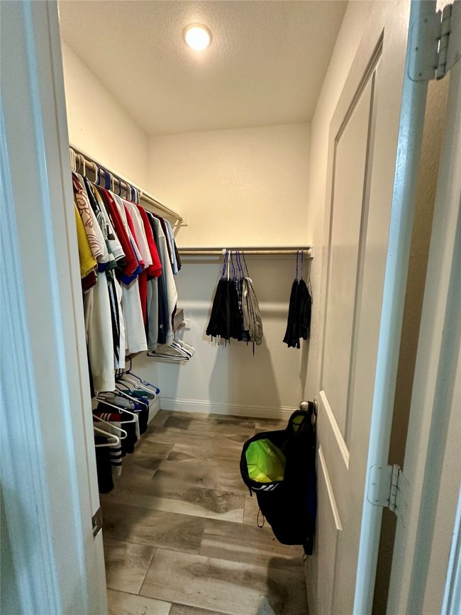 Walk in closet with wood finished floors | Image 27