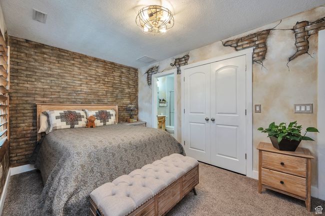 Bedroom with light colored carpet, visible vents, baseboards, and a closet | Image 16