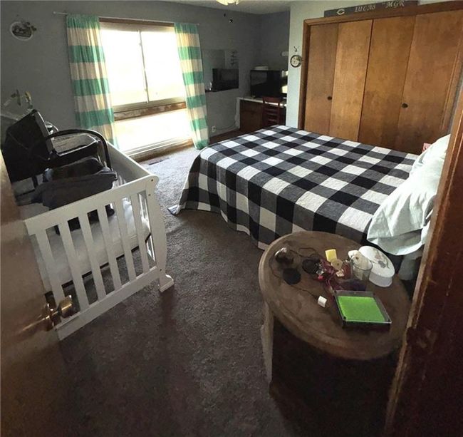 Bedroom 1, east-facing and featuring roomy closet, ceiling fan and screened window to let in a lovely breeze | Image 10