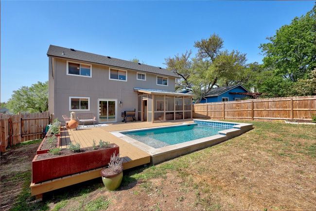 Back of house with a fenced backyard, a wooden deck, a sunroom, and a lawn | Image 27