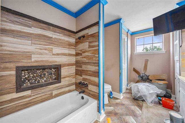 Some of the most expensive items have already been completed. The tile tub surround is a brown marble looking tile. | Image 19