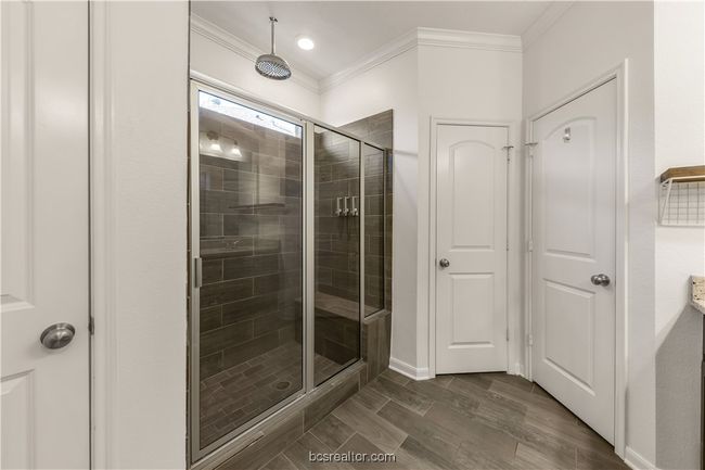 Bathroom with an enclosed shower, wood-type flooring, and ornamental molding | Image 27
