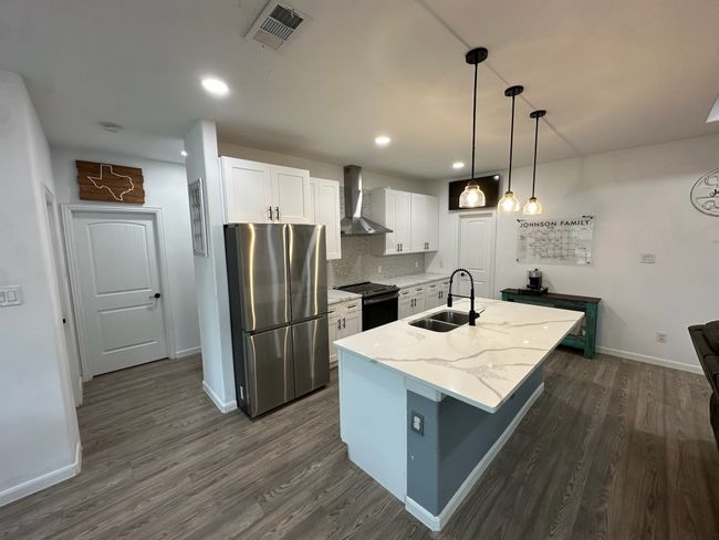 Washroom with washer and clothes dryer and wood finished floors | Image 20