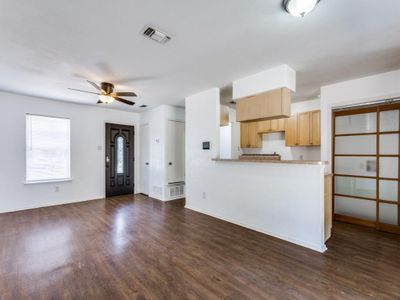 Kitchen with dark hardwood / wood-style floors, kitchen peninsula, light brown cabinetry, and ceiling fan | Image 3