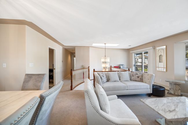 Living area with a chandelier, baseboards, and carpet floors | Image 12