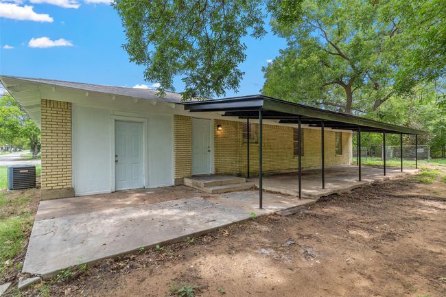 Rear view of house with brick siding and central air condition unit | Image 21