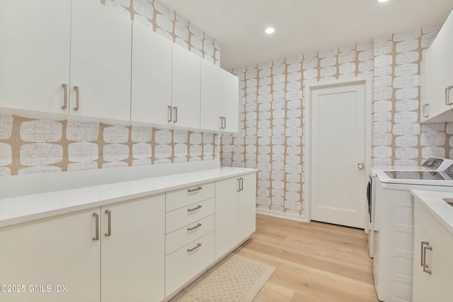 This room boasts 22 cabinets and drawers and and 8 foot long counter perfect for laundry folding or holiday wrapping. New Washer and Dryer. | Image 40