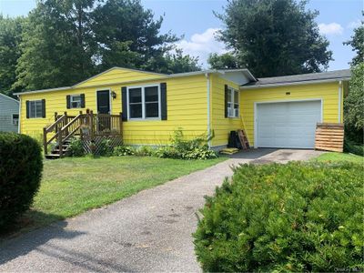 View of front of home featuring a garage, a front yard | Image 2